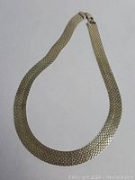 Full view of the vintage sterling silver necklace laid flat to show its complete shape and size.
