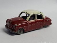 Side view of red and white vintage Lesney die cast toy car showing paint chips and wear.