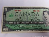 Front view of the first original 1967 Canadian one dollar centennial note featuring Queen Elizabeth II and bilingual text.