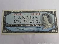 Front view of the 1954 Canadian five dollar banknote showing serial number, Queen Elizabeth II portrait, and signatures.