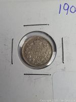 Front side of the 1905 silver Canadian 5 cent coin within a protective cardboard holder