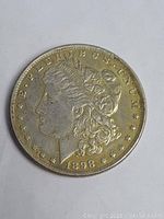 Obverse of the 1898 Morgan Silver Dollar Coin showing Lady Liberty with inscriptions and date.