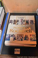 Front cover of the Norman Rockwell coffee table book showing title with 352 magazine covers collage.