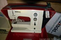 Front view of Bernina Record sewing machine inside red carrying case