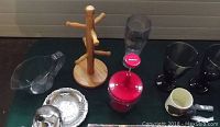 Photo of wooden mug stand, metal devilled egg tray, glass mugs, food chopper, butter dish, and other small kitchen items