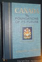 Blue hardcover book front cover showing title, author, publication details, and coat of arms emblem