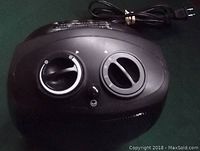 Close-up of black Airworks heater control panel with two knobs for fan and thermostat settings