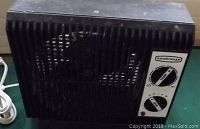 Black Classic brand electric heater with fan grille, dual control dials for fan and thermostat