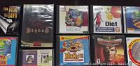 Top left section of the lot showing From Dusk Till Dawn game, Diablo, World Atlas, diet software, and other CD-ROMs in jewel cases.