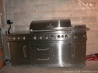 Front view of closed stainless steel grill showing overall condition