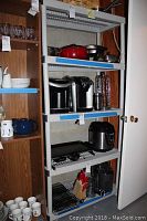 Two plastic shelving units holding kitchenware, appliances and miscellaneous household items.