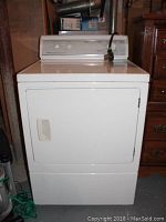 Front view of white Amana electric dryer with single drying door and recessed handle.
