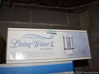 Box displaying Living Water II filtration system with two clear filter chambers and white base.