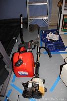 View of the edger, gas can, and blower handle showing the setup and condition.