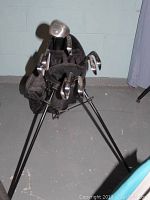 View of golf clubs inside black golf bag with stand visible, showing multiple clubs with metallic heads and shafts.