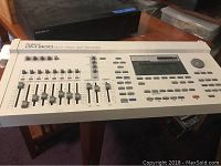 Photo of Roland DM-800 Multi Track Disk Recorder showing faders, knobs and control buttons.