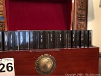 Wooden box open showing row of CD-ROM jewel cases labeled by decade inside