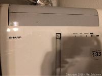 Front view of Sharp air conditioner showing control panel and branding