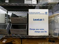 Shelf with three metal bins and Kangen Water Generator box