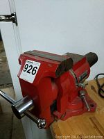 Red Ironman table vice mounted on wooden work table