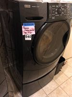 Front view of washer and pedestal showing overall condition and dimensions label.