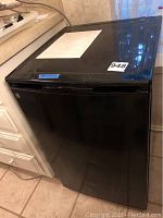 Front view of GE black mini fridge with label 948.