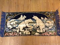 Full view of the velour tapestry showing three polar bears on icebergs in a snowy icy landscape with dark blue background and decorative border.