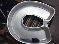 Full view of the Wilton metal horseshoe-shaped cake pan with a marker for size reference, showing its overall shape and condition.