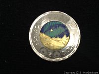 Obverse side showing the colored Northern Lights design on the 2017 Canadian toonie coin.