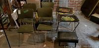Four vintage green vinyl upholstered chrome chairs with two metal TV trays and one extra tray top in basement setting