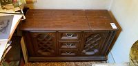 Full view of closed wooden stereo cabinet showing the top and surroundings.