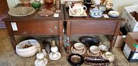 Pair of vintage wooden end tables with various small household items on and around them, showing the overall size and condition of the tables.