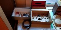 Photo showing boxes with assorted advertising keychains and cufflinks.