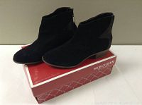 Pair of black Skechers ankle boots shown on top of a red and white Skechers shoebox.