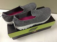 Pair of grey Skechers Go Walk women's shoes size 9 resting on top of the original Skechers box, showing shoe design and color.