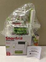 Starfrit spiralizer new in box with instruction manual visible, wrapped in plastic.