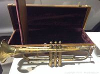 Full view of antique La Monte Superior trumpet outside of its case, showing overall condition and size.