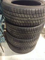 Stack of four used Uniroyal Tiger Paw tires