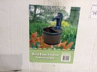 Photo of the box showing the water barrel fountain with pump, outdoors styled on the packaging.
