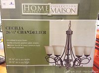 Photo of Home Collection Maison Cecilia chandelier box with product info and image.