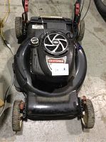 Top view of the Craftsman 700 series lawn mower showing the pull start recoil mechanism, fuel cap, and cutting deck area.