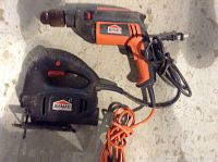 Orange and black Jobmate drill and black Jobmate jigsaw on concrete floor
