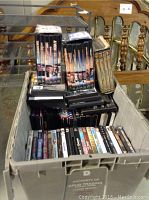 Plastic crate filled with about 40 DVD cases. Some DVDs are in boxed sets including several titled 'Avengers'. Various other movies and TV series are included in individual DVD cases.