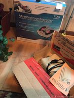 Full view of the Advanced Foot Energizer box with product details and the Thermophore heating pad packaging seen behind.