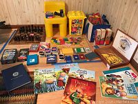 Wide layout showing chess sets, card games, children's books, craft books, and colorful USA puzzle
