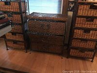 Three wicker and metal storage units arranged side by side on a wooden floor; two units with five drawers and one with three drawers.