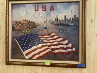 Framed painting featuring the USA flag, runner, and Olympic cityscapes labeled Athens 1896 and Atlanta 1996 with Olympic rings and USA text.