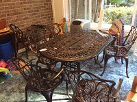 Full view of rectangular outdoor dining table surrounded by six chairs