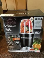 Closed box of NutriBullet Magic Bullet blender showing branding, motor power details and included parts