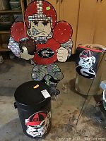 Full view of three items: light-up football player yard figure, cooler with bulldog image, and yard flag with bulldog logo.